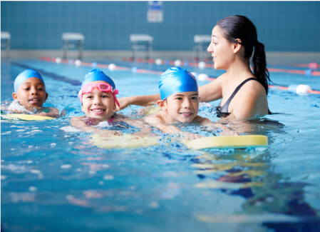 Group. Kids swimming together in swimming pool